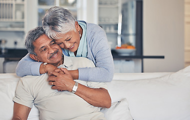 Image showing Senior couple, hug and love in care, support or embrace and bonding on living room sofa together at home. Happy mature man and woman smile in happiness for romance, weekend break or relax in house