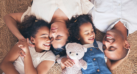 Image showing Above mother, father and children in family home for love, security and support with care. African woman, man and kids lying on floor for happiness, bonding and relax with parents and wellness