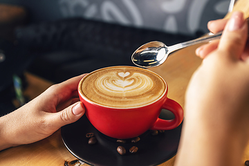 Image showing Woman hand with cup of coffee