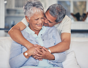 Image showing Love, hug and a senior couple on a sofa in the living room of their home together during retirement. Support, relax and a elderly man embracing his pensioner wife in a house for relationship bonding