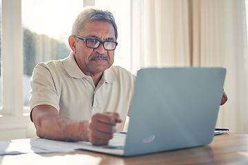 Image showing Senior man, laptop and documents in finance or budget planning or checking bills and expenses at home. Mature male person working on computer, paperwork or insurance in retirement plan or investment