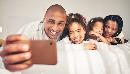 Image showing Home, bed and father take selfie of happy family in morning for social media, memory and love. African woman, man and kids lying on bedroom for profile picture, vacation and relax on fun holiday