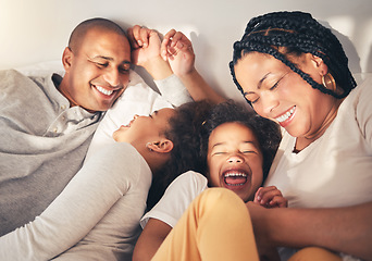 Image showing Family, bed and laughing in morning in happy home while playing, tickle or bonding with love. African woman, man and kids lying in bedroom for security, wake up and relax with funny mother and father