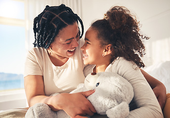 Image showing Play, happy or mother with kid on bed in the morning with teddy bear, care or love in family home. Single parent, hug or funny mom with girl child in bedroom to laugh or relax with smile or freedom