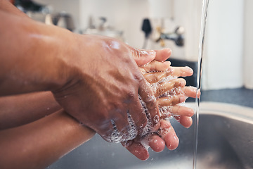 Image showing Soap, water and learn to clean hands, hygiene and people in kitchen with parent and child, health and wellness. Safe from virus, knowledge and washing with foam, closeup and healthy at home with care