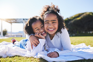 Image showing Portrait, family and a girl with her sister on the grass outdoor of their home together in summer. Face, smile and sibling children hugging on a field while happy about travel, vacation or holiday