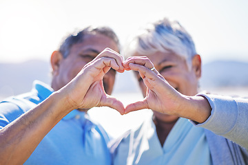 Image showing Heart, hands and senior couple at a beach with love, care and trust while bonding in nature together. Emoji, finger and old people with thank you, support or sign of kindness, hope or freedom at sea