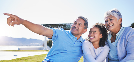 Image showing Happy, talking or grandparents with child in nature bonding to relax with care in retirement on mockup space. Smile, grandmother or senior grandfather pointing with a kid on holiday in summer park