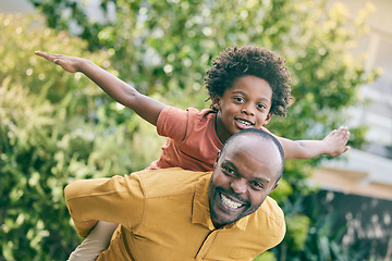 Image showing Portrait, flying boy on the back of his dad and fun with a black family in the garden together for games and play. Face, smile and piggyback with a man carrying his son in the backyard of their home