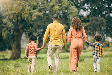 Image showing Parents, holding hands or kids walking in nature, park or field on holiday vacation together as a family. Back of mother, father or children siblings bonding to relax in countryside for love or trust