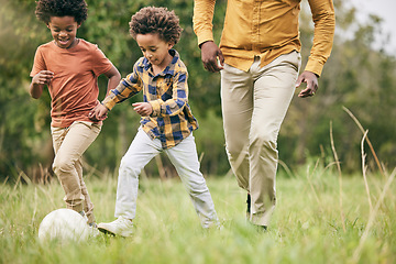 Image showing Family, ball and a boy playing soccer on a field outdoor for fun together with his happy brother. Football, fitness or game with a father and children running on grass for sport or physical activity