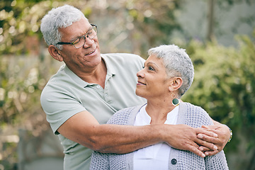 Image showing Hug, love and senior couple in a garden with care, trust and support, conversation and bond outdoor. Happy, marriage and elderly man with old woman in backyard embracing retirement, relax and smile