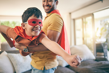 Image showing Dad, boy and superhero game in living room, flying and power with smile, care and bonding in house. Father, young son and mask with comic laugh, playful and lift in air, lounge and family home