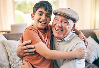 Image showing Happy, hug and portrait of child with his grandfather on a sofa in the living room for relaxing and bonding. Smile, love and senior man sitting and embracing a boy kid in the lounge of family home.