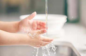 Image showing Child, washing hands and kitchen with foam in closeup for health, safety and stop bacteria in house. Kid, cleaning palm and soap with water, liquid or learning in bathroom for wellness in family home