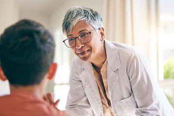 Image showing Mature doctor, smile and woman with child in consultation at hospital, healthcare and wellness. Pediatrician, happy and medical professional with kid in communication, help patient or check at clinic