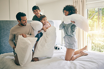 Image showing Pillow fight, happy parents and family of kids play in bedroom with energy, funny games and joke together at home. Excited mother, father and children laughing with bed cushion for crazy morning