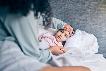 Image showing Mother, thermometer and sick child in bedroom with illness, virus or infection and caring parent at home. Mom checking kid or little girl with fever, cold or flu in health or medical attention in bed
