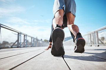 Image showing Fitness, running and a the back of a man at the start of his workout in the city for cardio or endurance training. Exercise, bridge and shoes of a male runner or athlete outdoor for a challenge