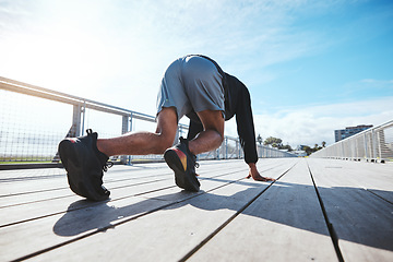 Image showing Fitness, man and a the back of a runner at the start of his workout in the city for cardio or endurance training. Exercise, bridge and shoes of a male athlete outdoor for a running challenge