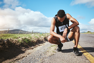 Image showing Tired, runner and man with fitness, breathing and exhausted with workout, sports and training. Person, guy and athlete outdoor, exercise or fatigue with rest, challenge and break with intense cardio