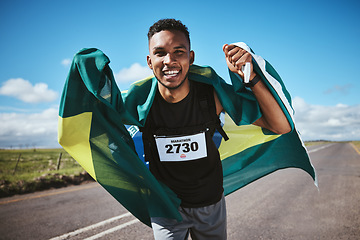 Image showing Portrait, fitness and flag of Brazil with a man runner on a street in nature for motivation or success. Face, winner celebration or health with an athlete cheering during cardio or endurance training