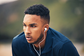 Image showing Outdoor, earphones and man with fitness, tired and sweat with workout, training and breathing. Person, guy and athlete outside, streaming music and exercise with fatigue, listening to audio and relax