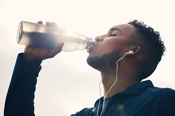 Image showing Outdoor, fitness and man drinking water, exercise and hydration with wellness, nutrition or training. Person, athlete or runner with liquid, thirsty or outside with health, sports or cardio challenge