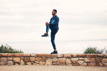Image showing Fitness, man stretching legs and outdoor running workout on road for health and wellness. Sports, motivation and healthy mindset, training and stretch for runner exercise or marathon with headphones.