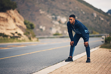 Image showing Tired runner man, mountain and rest with earphones, music and thinking for fitness, health and wellness in street. Guy, outdoor and training for marathon with fatigue, vision and burnout in nature