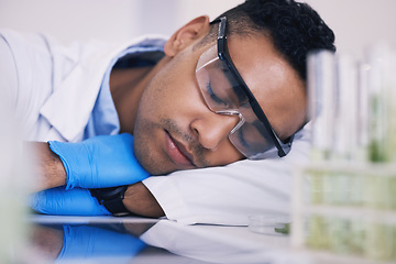 Image showing Scientist, man sleeping and tired in laboratory for plants research, medicine and pharmaceutical study at table. Medical or science person with career dream, fatigue and depression by green test tube