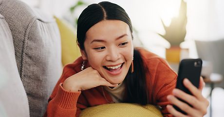 Image showing Asian woman, selfie and lying on sofa with peace sign and love for profile picture, vlog or social media at home. Happy female relaxing with smile and hand signs for photo or online vlogging on couch