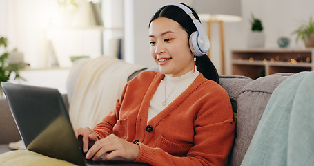 Image showing Laptop, headphones and asian woman on couch with work from home opportunity in online or website copywriting. Remote worker or person in china typing on her computer and listening to music at home