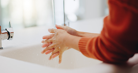 Image showing Water, washing hands and cleaning at sink in bathroom for hygiene, wellness or health. Skincare, liquid and woman clean hand to remove bacteria, germs and dirt, sanitary and disinfection in home.