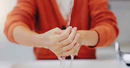 Image showing Washing hands, water and cleaning at sink in bathroom for hygiene, wellness or health. Skincare, liquid and woman clean hand to remove bacteria, germs and dirt, sanitary and disinfection in home.