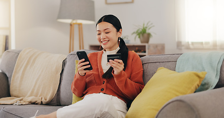 Image showing Happy woman, credit card and phone on couch online shopping, ecommerce and fintech easy payment. Asian person in China typing bank information on cellphone for discount or finance transaction at home