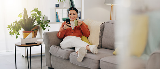 Image showing Asian woman, phone or music headphones on relax sofa in house or Japanese home living room. Smile,enjoy or happy student with mobile technology for podcast, dance radio or audio playlist app in comfo