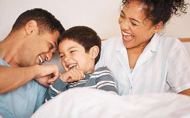 Image showing Happy, tickle and smile with family in bedroom for playful, morning and love. Care, support and wake up with parents and boy child laughing in bed at home for weekend, positive and relax together