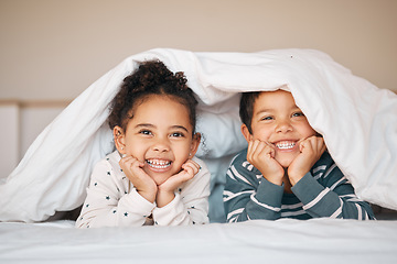 Image showing Siblings, happy and portrait of children in bed in blanket for bonding, love and fun at home. Family, childhood and face of boy and girl in bedroom for relax, resting and smile together in morning