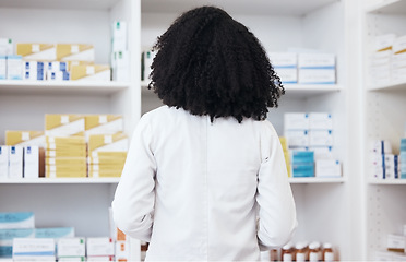 Image showing Healthcare woman, pharmacy and medicine on shelf with pills or medication for inspection or inventory. Back of pharmacist person or medical staff to check stock or pharmaceutical product at drugstore