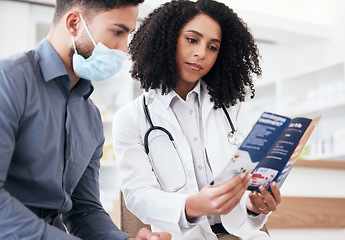 Image showing Doctor, clinic patient and healthcare brochure for virus, disease and pharmacy information, advice or support. Pharmacist woman and sick man in face mask for covid tips, compliance or safety document