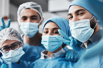 Image showing Healthcare, teamwork and surgery, selfie in operating room in medical emergency at hospital. Face of doctor, nurses and surgical team taking picture in operation with ppe, face mask and scrubs.