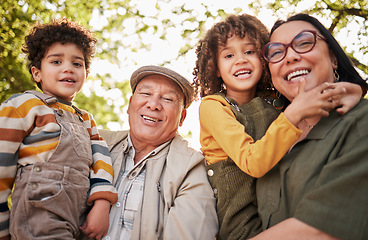 Image showing Grandparents, children and portrait with a smile in park, garden or happy family relax together outdoor in backyard. Kids, hug grandmother and grandfather in nature on holiday or vacation with love