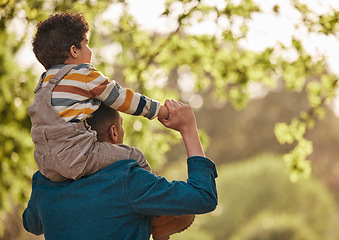 Image showing Piggyback, love and father with child in park for support, playful and games. Relax, freedom and adventure with man carrying baby in nature for family, summer and vacation together with mockup space