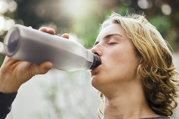 Image showing Health, fitness and drinking water with man in nature for workout, exercise and sports. Wellness, marathon and training with face of person and bottle in forest for cardio, challenge and performance