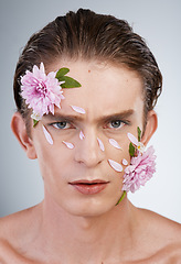 Image showing Serious, skincare and flowers with portrait of man in studio for beauty, natural and creative. Glow, cosmetics and aesthetic with face of model on white background for makeup, spa and floral