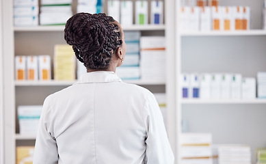 Image showing Pharmacy, search and back of woman in store for medicine, inventory and medical. Healthcare, retail and wellness with person and shopping shelf for supplements, pills dispensary and prescription