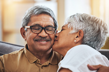 Image showing Love, kiss and senior couple on sofa for bonding, healthy marriage and relationship in living room. Retirement, relax and happy man and woman on couch embrace for trust, commitment and care at home