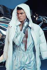 Image showing Futuristic, fashion and man with jumpsuit and vaporwave ski style with sci fi and gen z clothing in studio. Art, creative and young male model with trendy, cool designer clothes and cyberpunk jacket