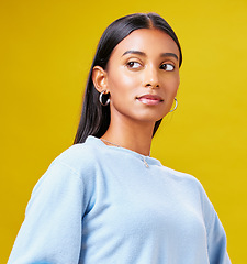 Image showing Beauty, fashion and thinking with an indian woman on a yellow background in studio for trendy style. Mindset, idea and clothes with a young gen z model posing in clothes outfit for a magazine